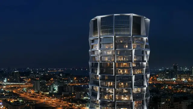 Binghatti Circle tower facade at night above the city skyline