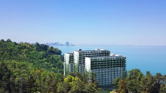 Mziuri Gardens towers among wooded hills above the Black Sea, with Batumi in the distance