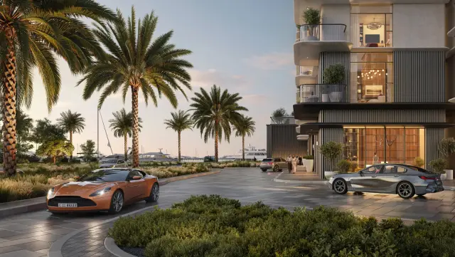 Pier Point residential building and arrival drive lined with palm trees at sunset, Rashid Yachts and Marina