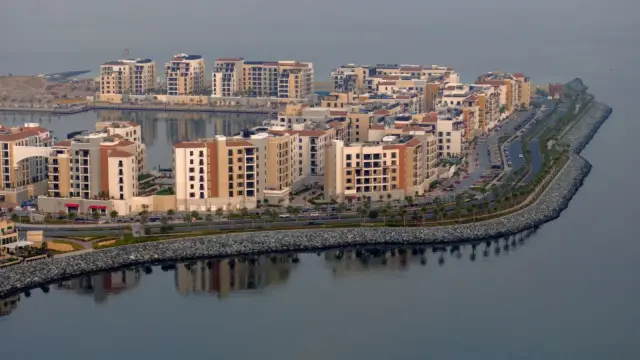 Aerial view of Port de La Mer waterfront community at dusk