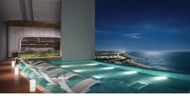 Rooftop pool bar with night coastline view