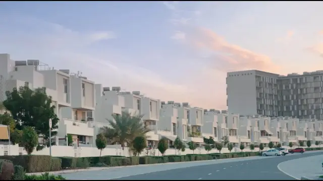 Row of contemporary South Bay townhouses along a landscaped street at sunset