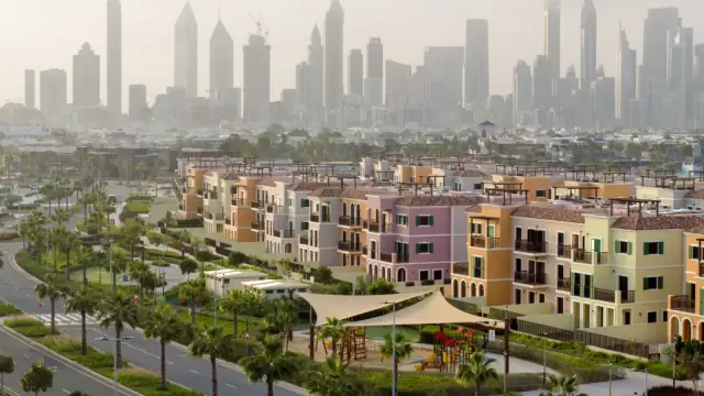 Sur La Mer street view with playground and skyline backdrop