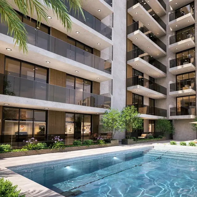 Outdoor swimming pool framed by palms and the balconies of Taraf 3 Residence